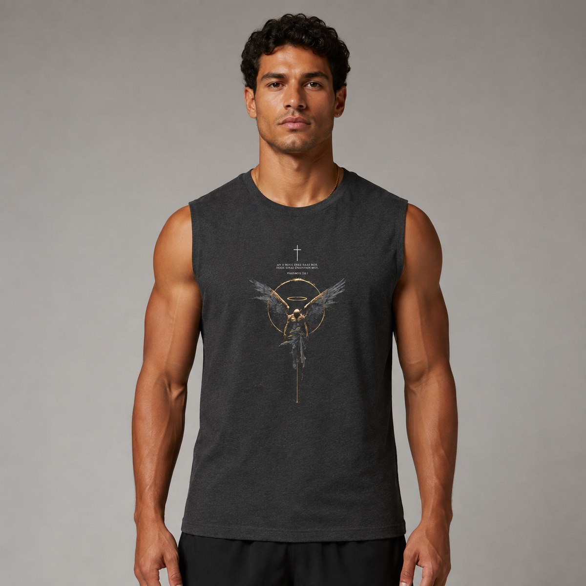 A man wearing a dark charcoal gray sleeveless muscle tank top with a gold and white graphic of a winged figure and the text 'GOD IS NOT TRUSTED' on the front, set against a plain gray studio background.