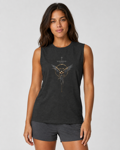 A woman modeling a dark charcoal gray sleeveless athletic tank top with a gold and white graphic of a winged figure inside a circle, paired with matching gray athletic shorts, against a light gray studio background.