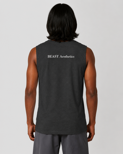 A man viewed from behind wearing a dark charcoal gray sleeveless muscle tank top with 'BEAST Aesthetics' printed in white text on the upper back, paired with gray sweatpants against a light gray studio background.