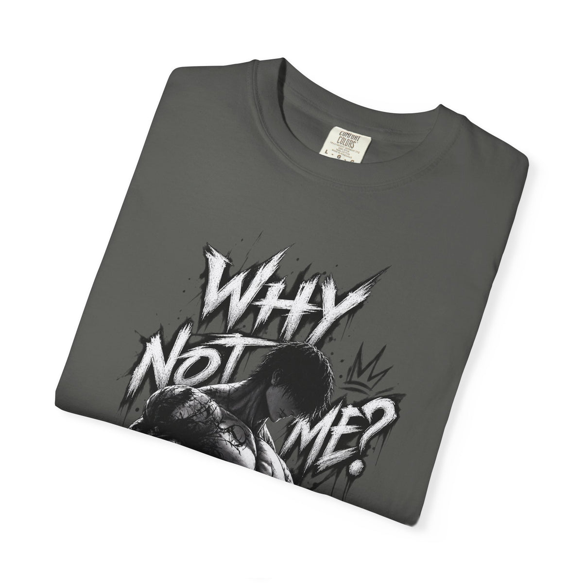A dark gray folded t-shirt with a black and white graphic print featuring the text 'WHY NOT ME?' and an anime-style character illustration, displayed on a clean white background.