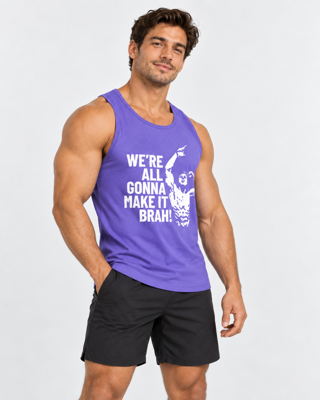 A muscular man wearing a purple tank top with a white graphic print and black athletic shorts, standing against a light gray studio background.