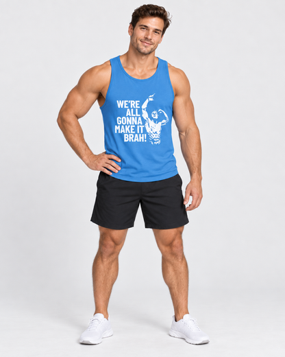 A muscular man modeling a bright blue tank top with a white graphic and text that reads 'WE'RE ALL GONNA MAKE IT BRAH' paired with black athletic shorts and white sneakers, set against a plain light gray studio background.