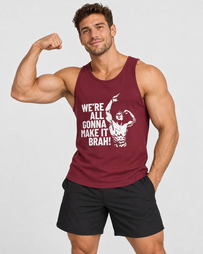A muscular man flexing his bicep while wearing a maroon tank top with a white graphic print that reads 'WE'RE ALL GONNA MAKE IT BRAH!' and black athletic shorts, against a light gray background.