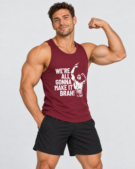 A muscular man flexing his bicep while wearing a maroon tank top with a white graphic print that reads 'WE'RE ALL GONNA MAKE IT BRAH' and black athletic shorts, against a light gray background.