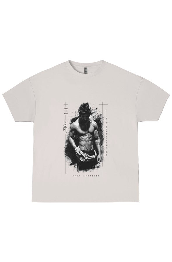 A light beige crewneck t-shirt featuring a black and white graphic print of a muscular man with a wolf head on the front, displayed flat against a white background.