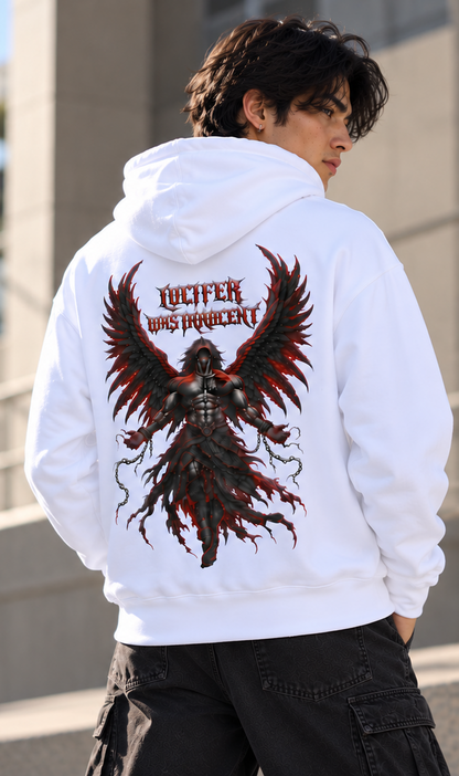 A man wearing a white hoodie from the back, featuring a large graphic print of a dark winged figure with the text 'LUCIFER WAS HEROCENT' in red and black. He is wearing black cargo pants in an outdoor setting.
